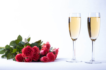 lush bouquet of red roses and champagne on a table