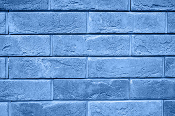 Obraz premium pattern of decorative gray slate stone wall surface as a background. tinted classic blue color trend 2020 year