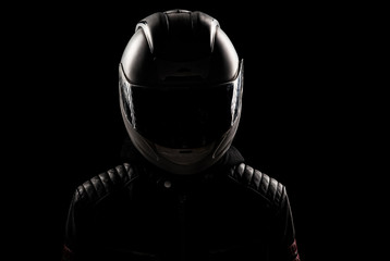 silhouette of a motorcyclist in a helmet and leather jacket