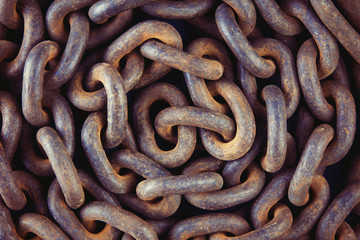 Old rusty chain close-up. Detail of the mechanism. A symbol of strength. Vintage background.