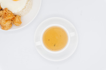 Buttermilk chicken rice with ingredients isolated on white with fried egg and salad.