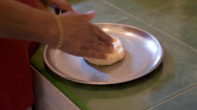 Sri Lankan housewife is making coconut roti