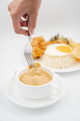 Buttermilk chicken rice with ingredients isolated on white with fried egg and salad. Chicken dumb into buttermilk sauce.