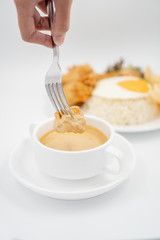 Buttermilk chicken rice with ingredients isolated on white with fried egg and salad. Chicken dumb into buttermilk sauce.