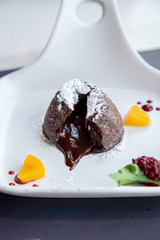 Warm dark chocolate lava cake on white plate