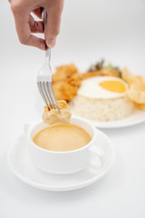 Buttermilk chicken rice with ingredients isolated on white with fried egg and salad. Chicken dumb into buttermilk sauce.