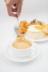Buttermilk chicken rice with ingredients isolated on white with fried egg and salad. Chicken dumb into buttermilk sauce.