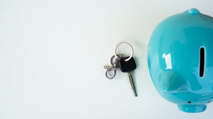 piggy bank and car key, saving money for new car