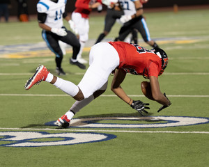 Young boy competing in a game of football