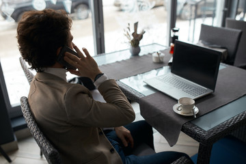 young businessman making appointment.close up back view photo, gadget, conversation concept