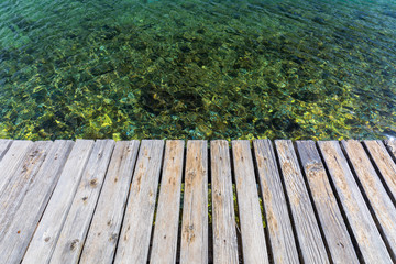 Wooden board empty over sea, can be used for display or present a product. Summer season. Empty...
