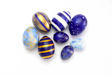 Happy Easter. Many easter eggs trendy colored classic blue, white and golden on white. Minimal style, top view, flatlay, copy space