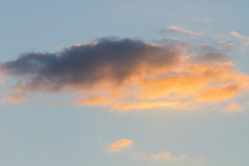 Naklejka na ściany i meble isolated yellow cloud cumulus (stratocumulus) cloud in a warm sky