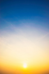 vertical Sky blue and orange light of the sun through the clouds in the sky
