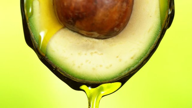 Super slow motion of splashing oil on avocado slice. Filmed on high speed cinema camera.