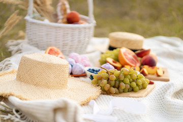 Stylish summer picnic on a white blanket.