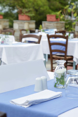 The charming retro Mediterranean outdoor restaurant, no people, empty seats and tables before dinner time