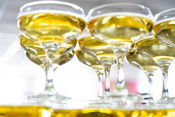 A pyramid of glasses of champagne. White sparkling wine in glasses.