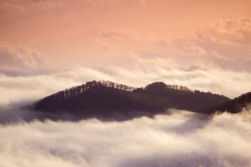 Foggy mountains at sunrise at long exposure. Concept: floating island