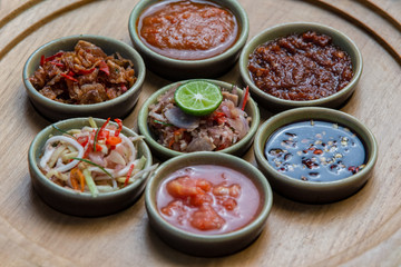 Small bowls of assorted sauces, dips, marinades and dressings.