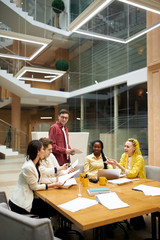 young people discussing a bigtime deal, checking bills, young business people closuring of a deal. woman pointing to the document, showing mistakes in report, young people having argument