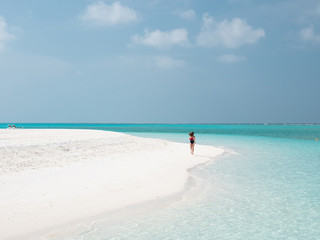 Fototapeta na wymiar Beautiful Woman Run on the Maldivian Beach.