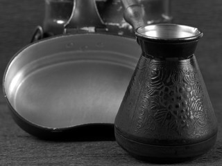 Cezve copper coffee maker with wooden handle for making coffee on an open fire. Background for the...