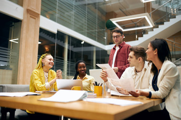 Business executives enjoying their work indoors. young people learning documents, analyzing sceme, chart