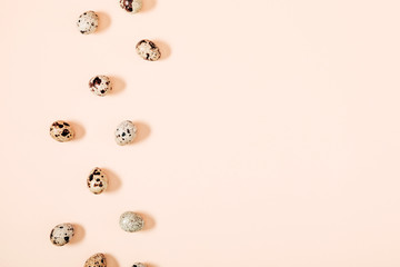 Quail eggs pattern. Big collection of quail eggs on beige background. Easter concept. Flat lay, top view, copy space