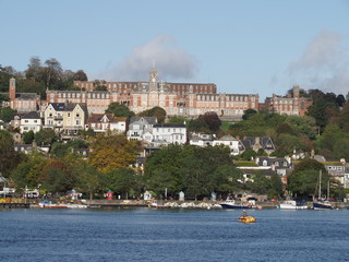 Britannia Naval College, also known as Dartmouth Naval College set on a hill in Dartmouth , Devon seen across the River Dart in sunshine