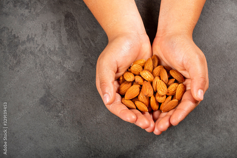 Sticker Hands holding peeled almonds - Prunus dulcis