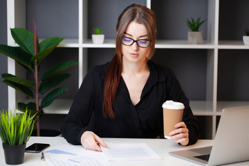 Successful business woman working at the computer in the office