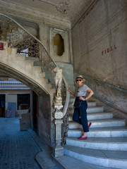 Woman standing on steps, Havana, Cuba