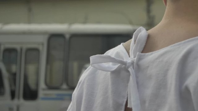 Doctor ties a straitjacket to a madman