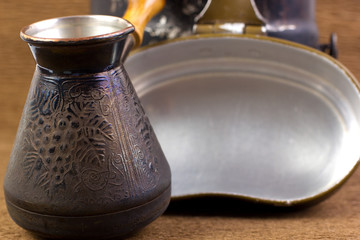 Cezve copper coffee maker with wooden handle for making coffee on an open fire. Background for the...