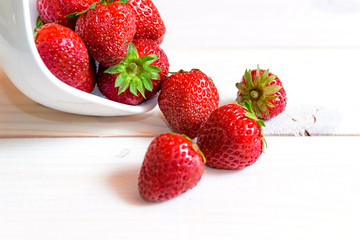 Ripe red strawberries on wooden table