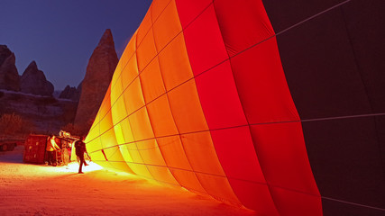 Hot air balloons preparing to fly at early morning in winter season in Cappadocia, Turkey
