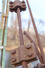 Old rusty steel cable mount