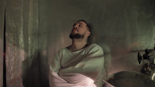 Psycho, crazy man in a straitjacket in a psychiatric hospital, creepy