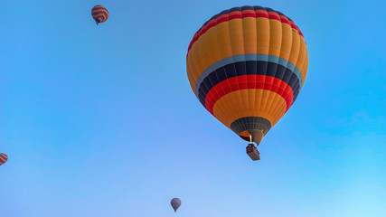 Hot air balloons preparing to fly at early morning in winter season in Cappadocia, Turkey