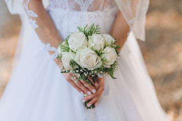 Wedding bouquet of roses close-up in the hands of the bride. Photography, concept.