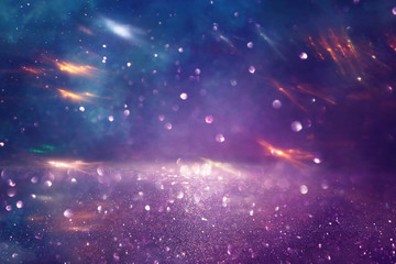 background of abstract glitter lights. gold, blue and purple. de focused
