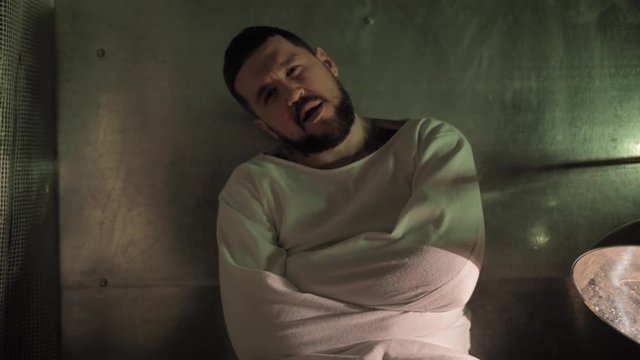 Psycho, crazy man in a straitjacket in a psychiatric hospital, creepy