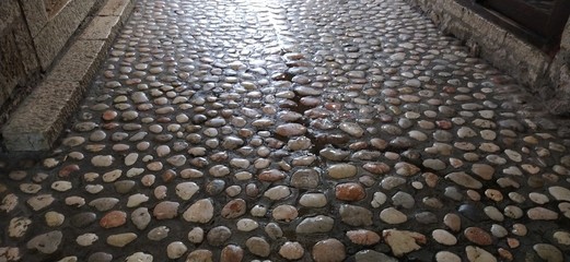 Paving stones made of round light stones similar to marble. Paved square in the old town of...