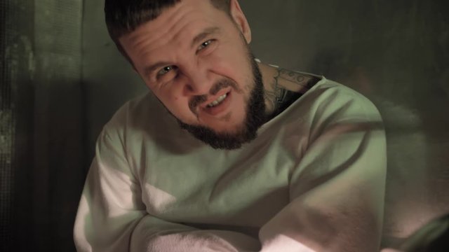 Psycho, crazy man in a straitjacket in a psychiatric hospital, creepy