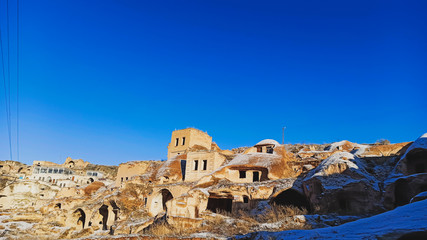 Ancient stone cave houses carved into the volcanic rock in Cappadocia, Turkey
