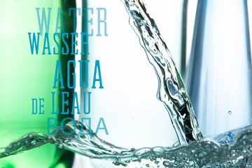 A bubbling surface and a stream of water against the background of plastic bottles