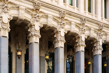 Architecture in detail at Cybele Palace in the historic heart of Madrid, Spain. Pillars, sculptures and ornamental hanging lanterns at Madrid city hall.
