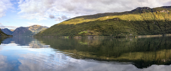 Panorama from water surface with bright reflection