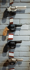 Pistols on showcase in gun shop closeup, nobody